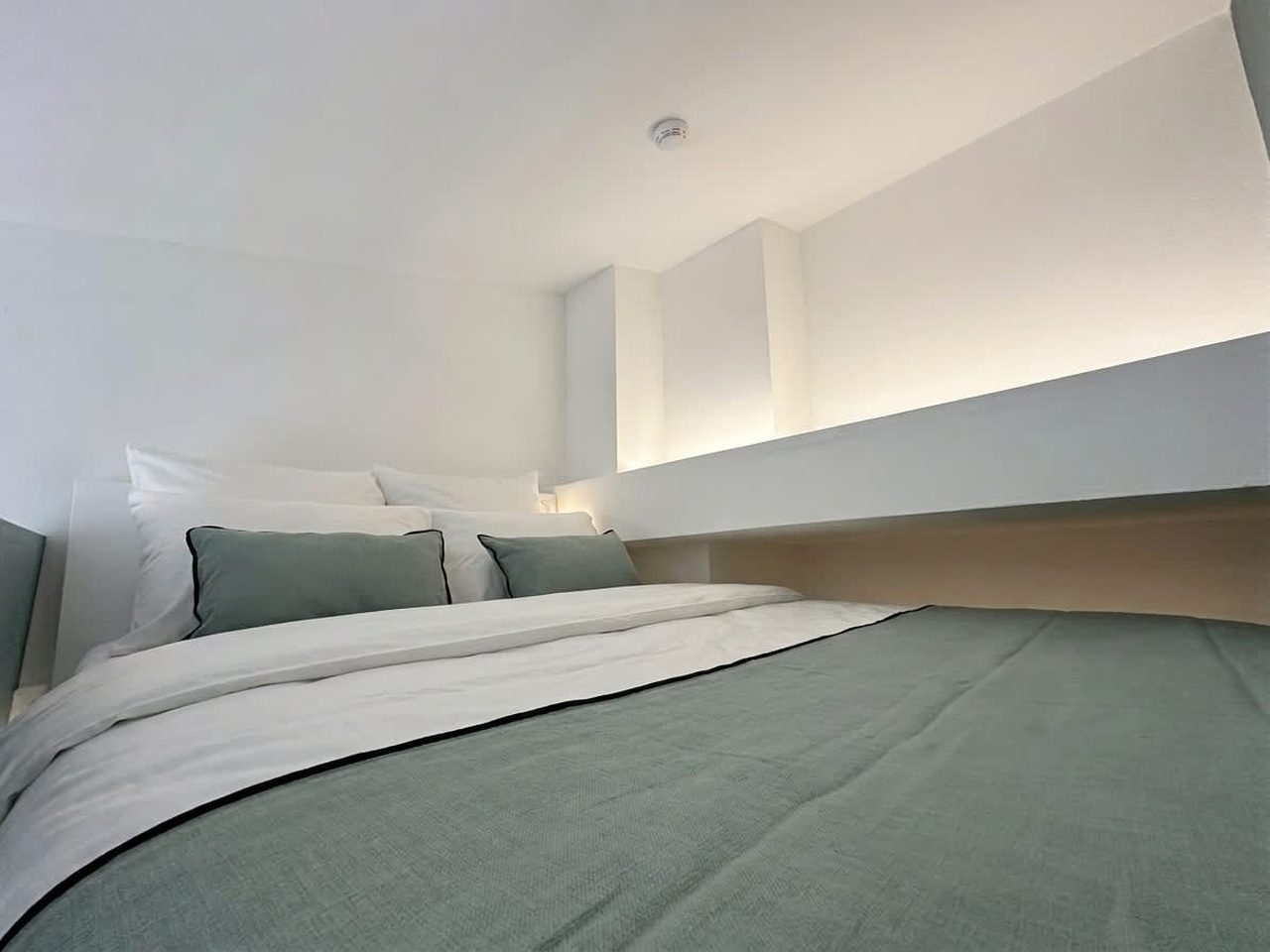 Chambre en mezzanine, couchage baigné de lumière douce